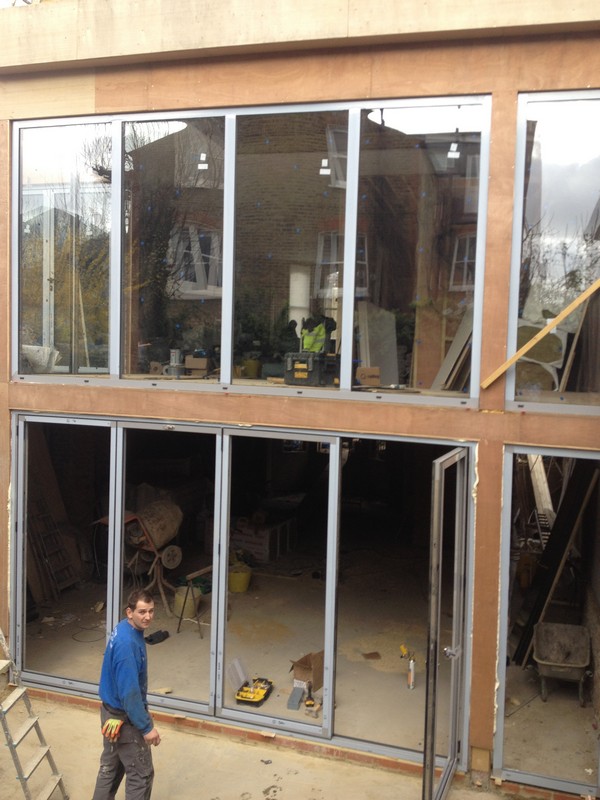 Aluminium bi-fold doors with two-storey glazing in Kensington