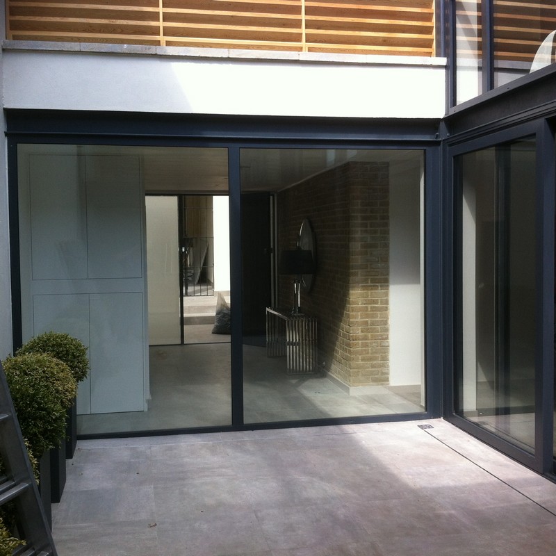 Floor-to-ceiling sliding doors opening to courtyard in Kensington