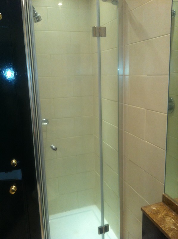 Frameless glass shower enclosure with chrome fittings in Kensington