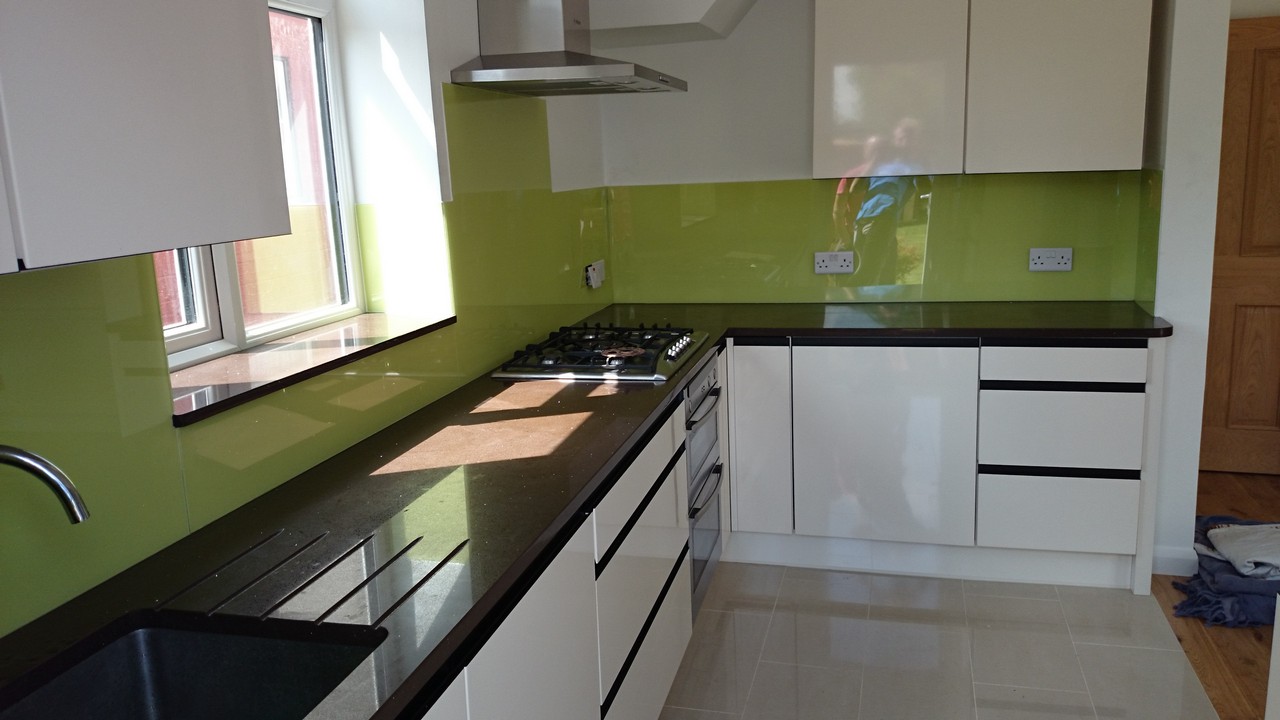 Lime green glass kitchen splashback installed by Kensington glaziers