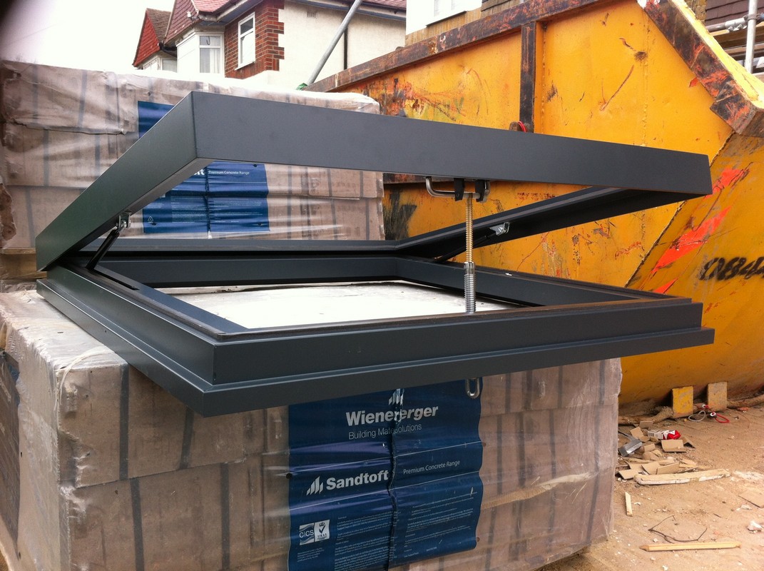 Opening flat roof skylight in anthracite grey installed in Kensington