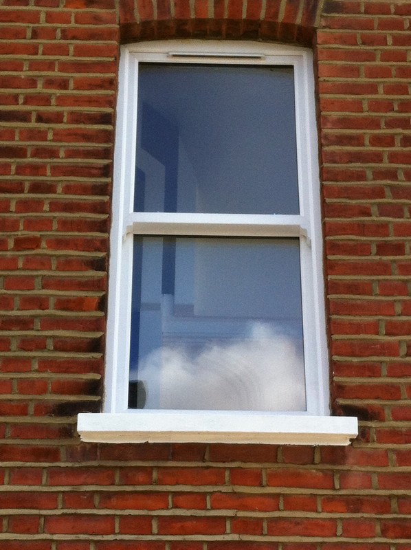 uPVC sash window on Victorian red brick house in Kensington
